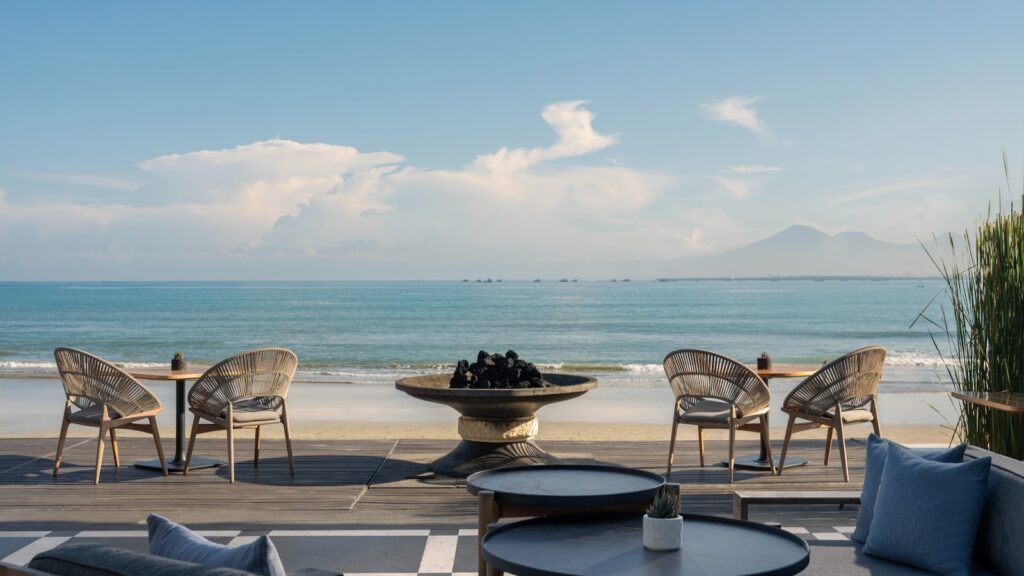 Beach loungers facing the ocean at a luxury Bali resort