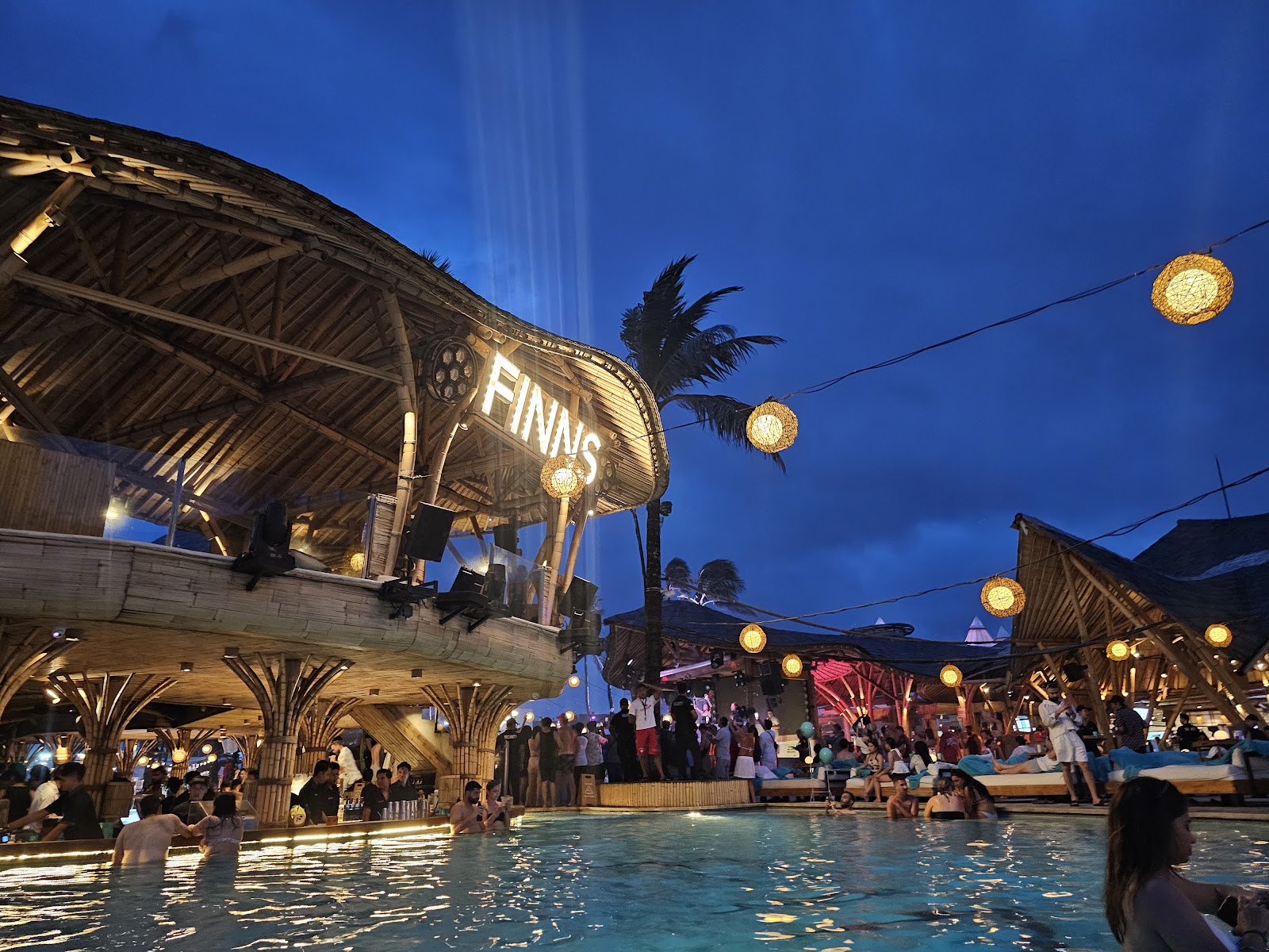 FINNS Beach Club lit up at dusk in Berawa