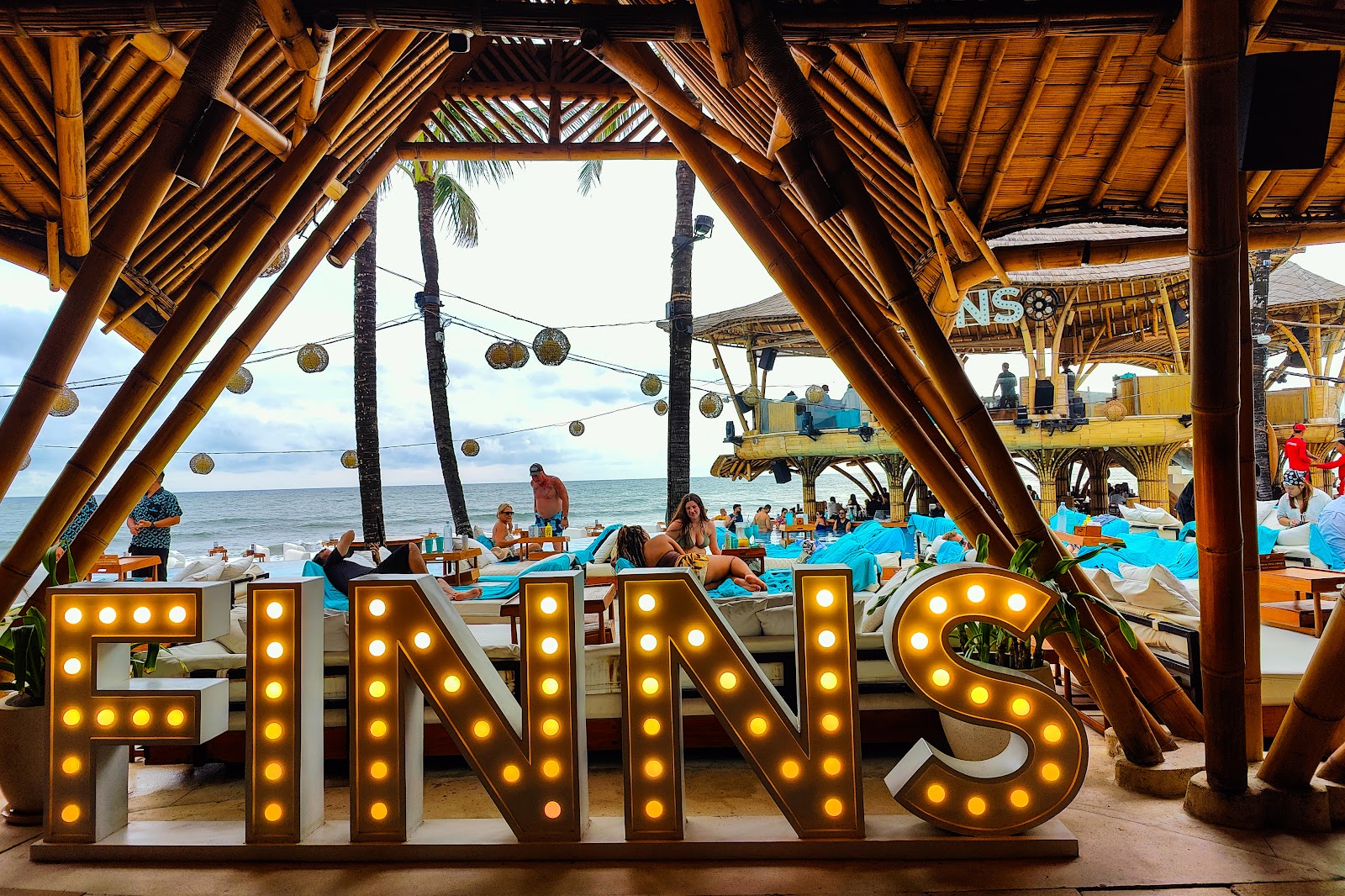 Illuminated FINNS sign at FINNS Beach Club in Canggu