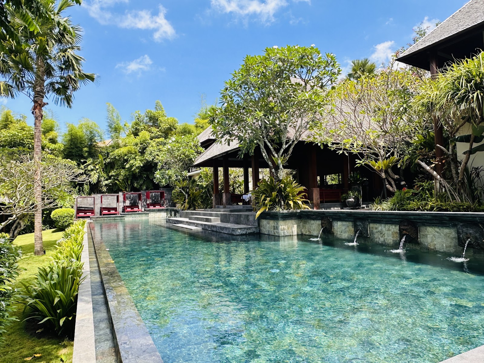 Lagoon pool surrounded by tropical gardens at La Reserve 1785 Canggu Beach
