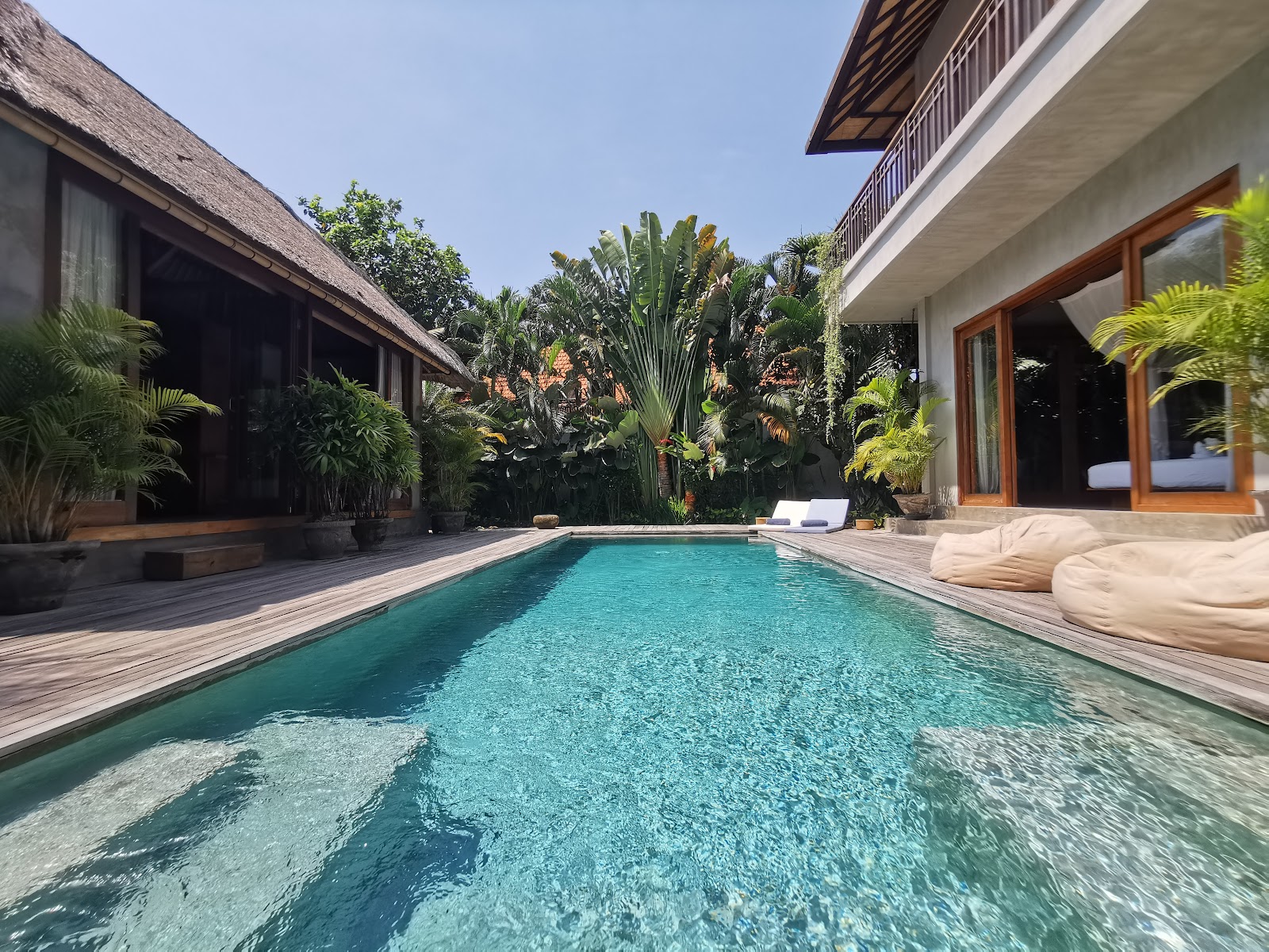 Long swimming pool surrounded by bungalows at Zin Berawa Villas and Bungalows