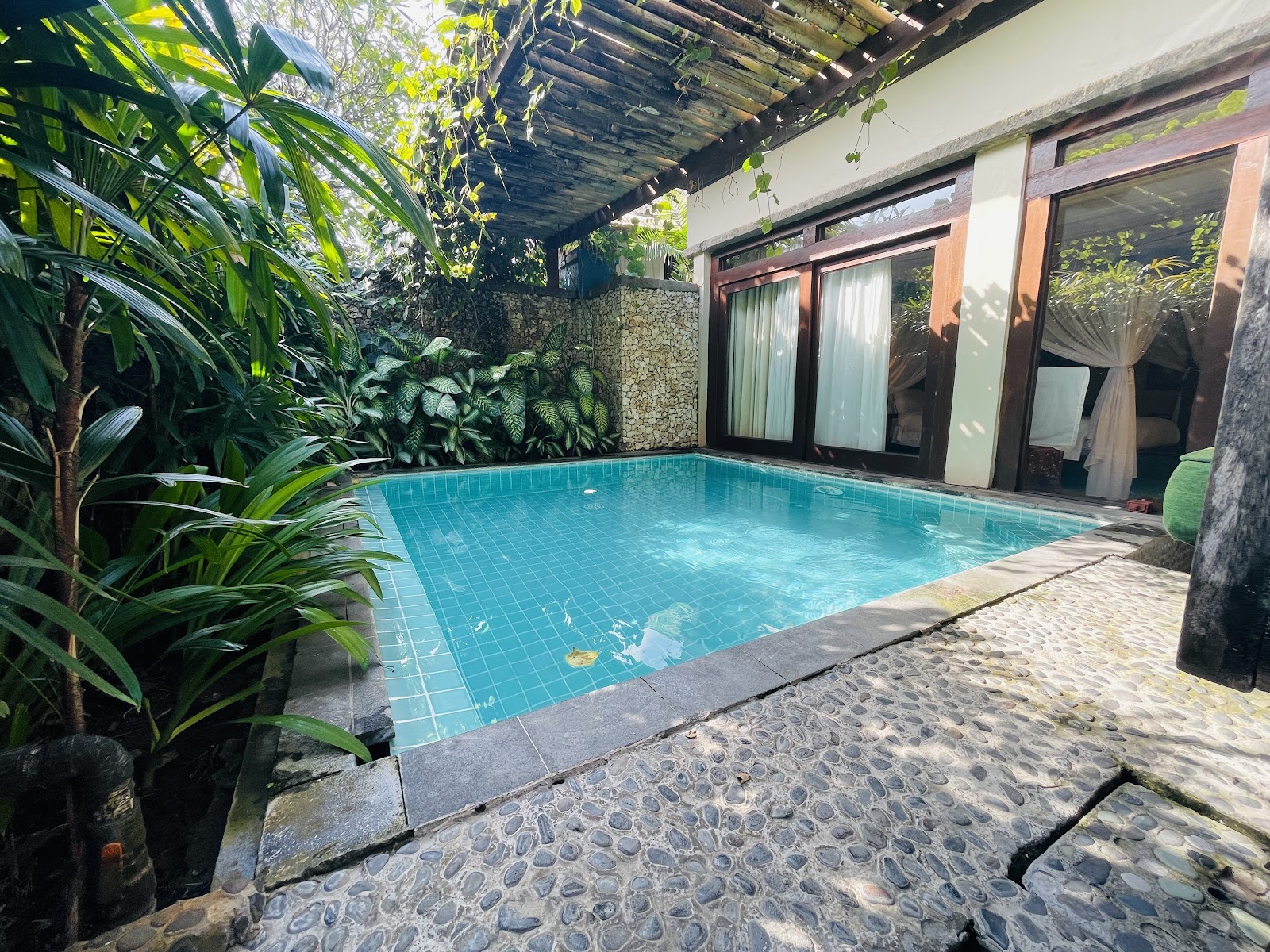 Private pool framed by Balinese decor at Hotel Tugu Bali
