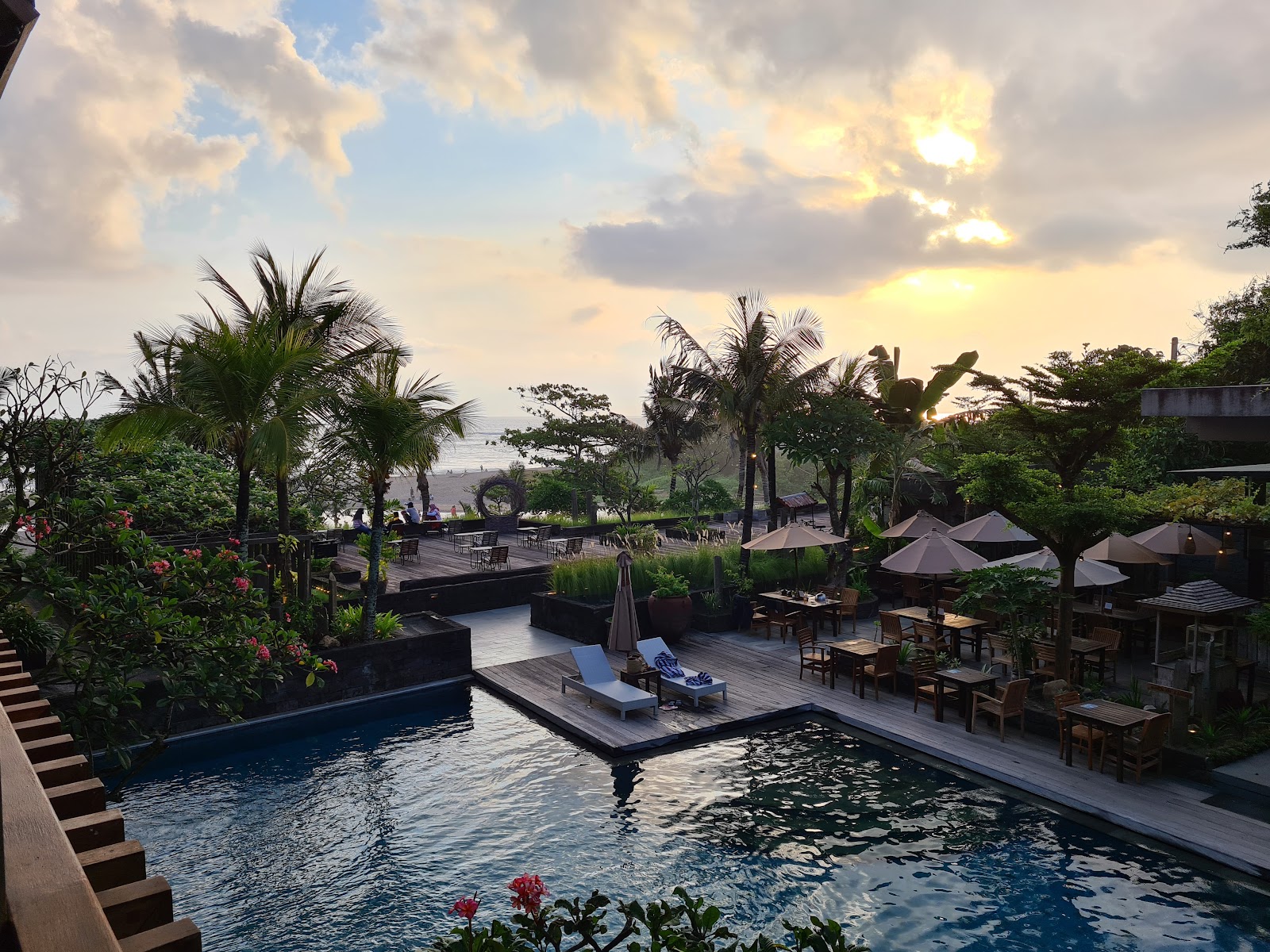 Rooftop pool with palm trees at Swarga Suites Bali Berawa
