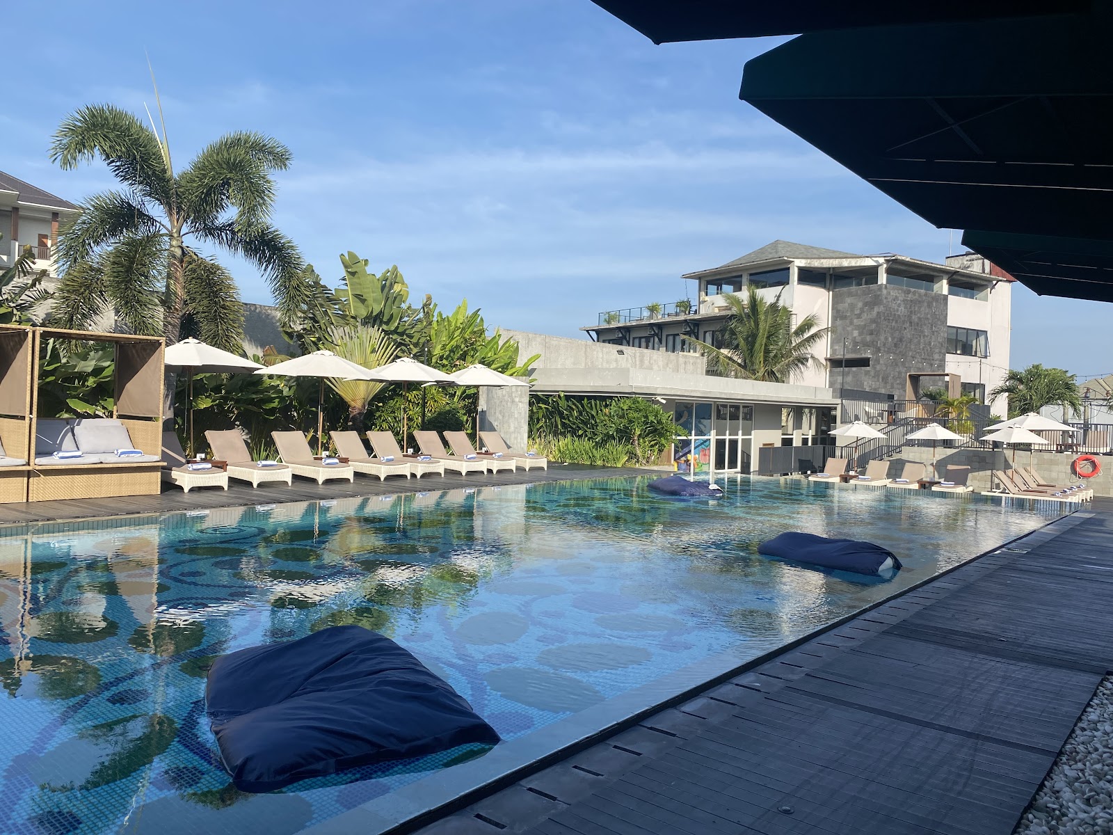 Swimming pool and sun loungers at Eastin Ashta Resort Canggu