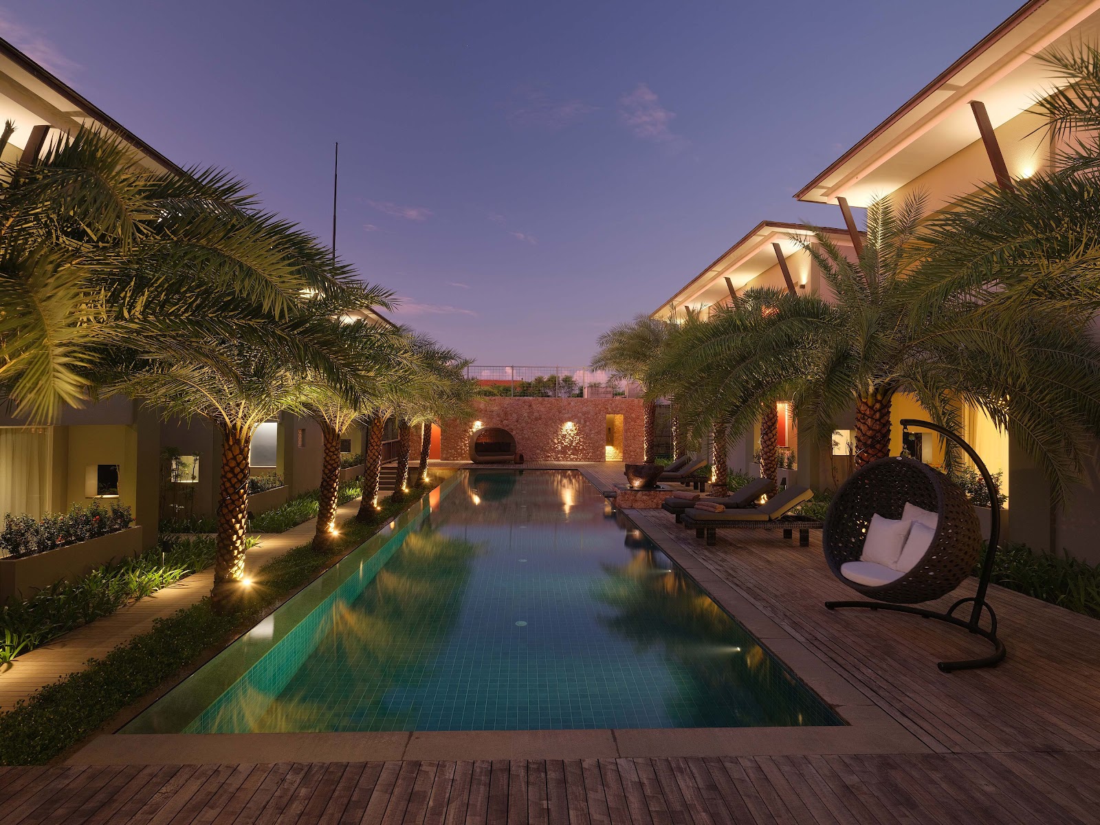 Swimming pool lit up at dusk at Chesa Canggu