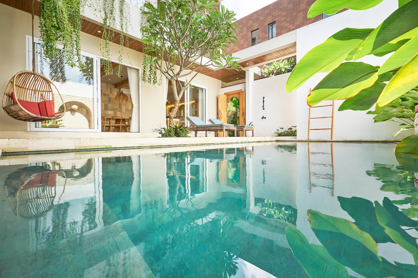 Turquoise pool surrounded by tropical plants at Luna Ola