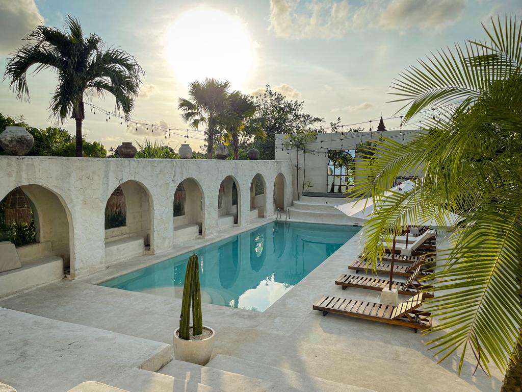 White arched building and pool at Hotel Sages in Canggu